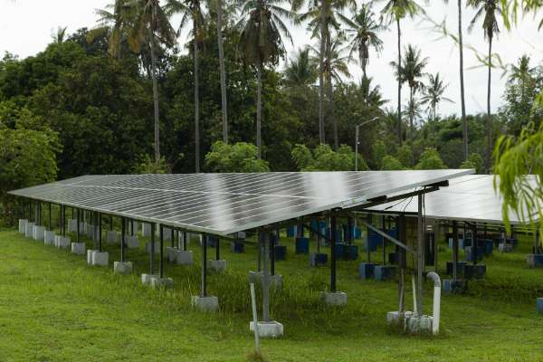 Solar panels mounted on the ground in this image from Shutterstock 