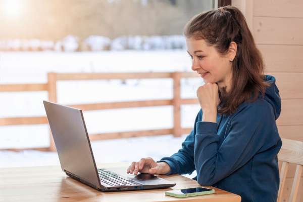 A young woman using a laptop on a table (Image: Shutterstock)