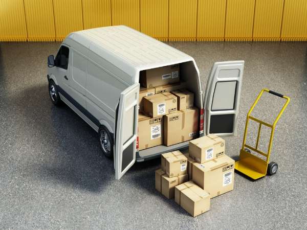 A moving van full of boxes being unloaded in this image from Shutterstock